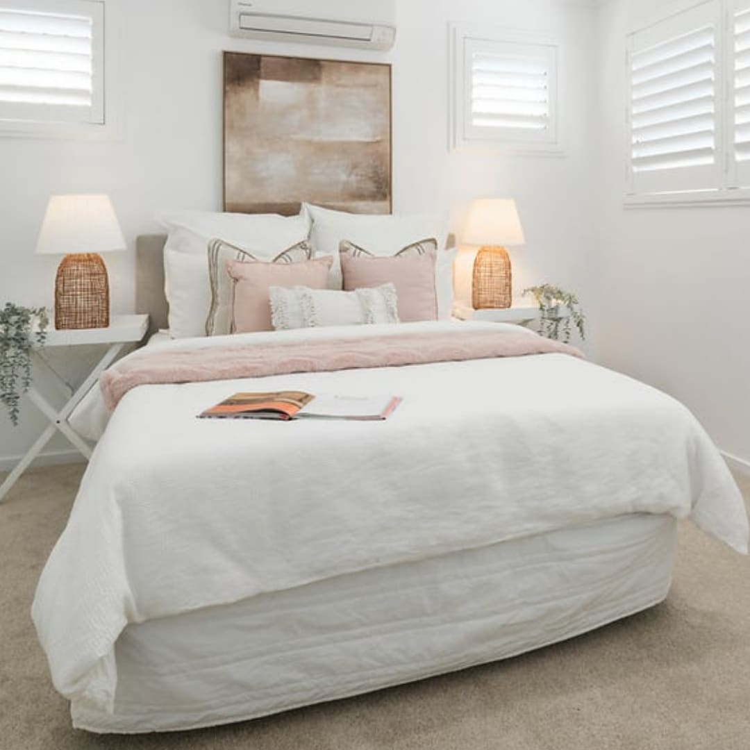 Styled one-bedroom apartment with a furnished bedroom and neutral bedding